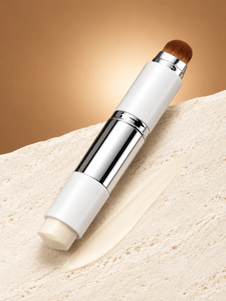 A close portrait-format studio photograph of the exact Luméa stick from the reference, opened at bot