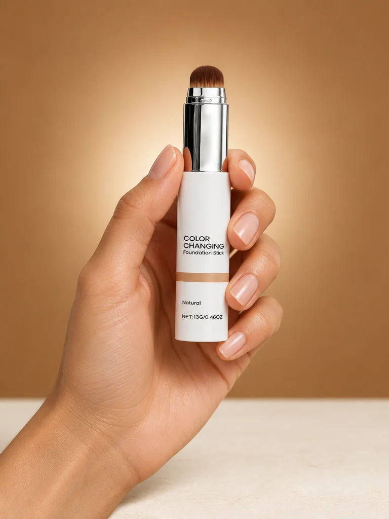 A portrait studio photograph showing the exact Luméa 2-in-1 stick at real scale in one adult hand: t